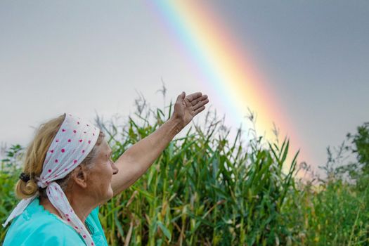 Grandmother points to the sky. Selective focus. Nature.