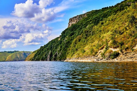 a large natural stream of water flowing in a channel to the sea, a lake, or another such stream.