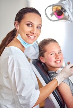 Always professional. Portrait of an attractive female dentist and her child patient