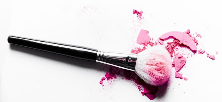 Beauty texture, cosmetic product and art of make-up concept - Brush with crushed eyeshadow and powder close-up isolated on white background