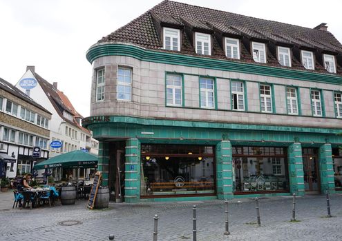 Bielefeld, NRW, Germany - July 23 2017 This corner house is located in Bielefeld's old town. It’s called ‘Kachelhaus’ (tile house) because of the cladding of the facade with  green porcelain tiles.