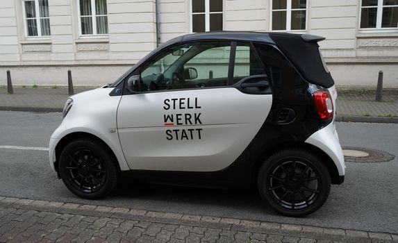 Detmold, NRW, Germany - Aug 20 2022 A cute electric car in black and white with a company name on it. Smart EQ ForTwo Electric Drive