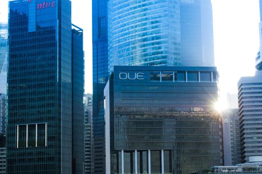 low angle view of singapore modern city buildings, OUE financial buildings logo