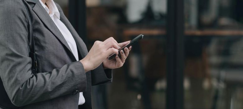 woman using apps on a mobile touchscreen smartphone. Concept for using technology, shopping online, mobile apps, texting, addiction