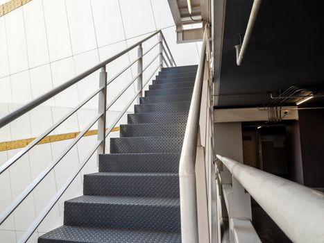 A fire escape ladder is attached to the side of a tall building