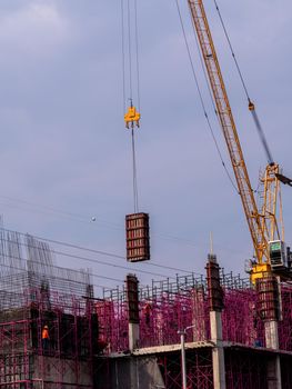 The pink scaffolding on the building under construction