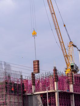 The pink scaffolding on the building under construction