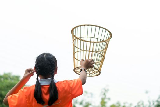 A girl in a basket holding position in a school chair-ball game