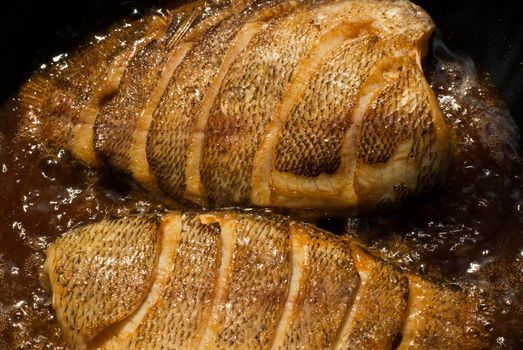 Sun-dried snakeskin gourami, fried in a pan