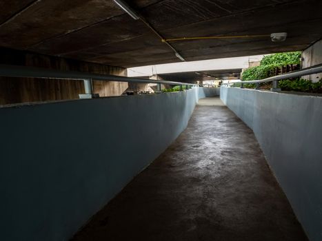 underpass walkway under the street beside the drainage canal