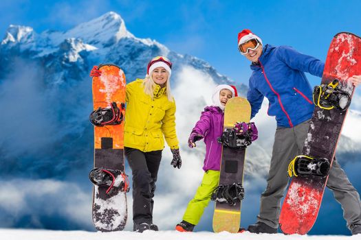 Happy family enjoying winter vacations in mountains. Playing with snow, Sun in high mountains. Winter holidays.