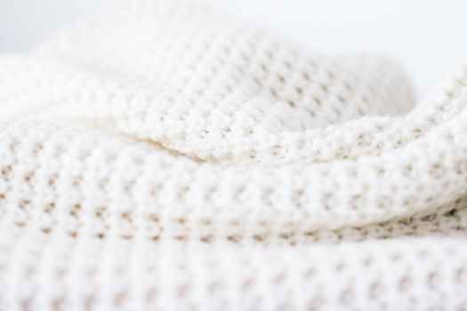 Knitwear, fabric textures and handmade items concept - Warm knitted clothes, soft and white