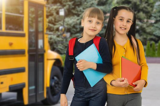 Little kids schoolchildren pupils students, the school bus. Welcome back to school. The new academic semester year start.