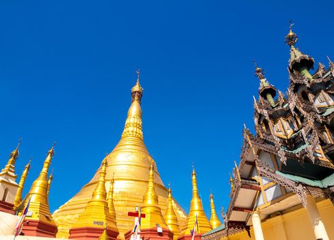 A group of golden pagodas under the blue sky of Myanmar