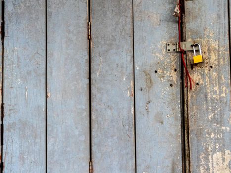 Old wooden folding door locked with a key