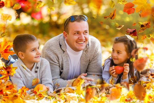 Happy family father and child daughter on a walk in the autumn leaf fall in park. High quality photo