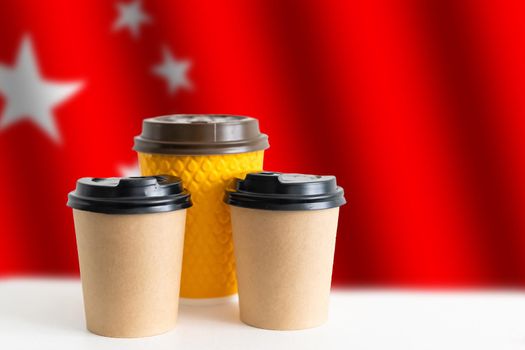 National flag of China on the tablet, textbooks, cup of hot drink coffee or tea on the table.