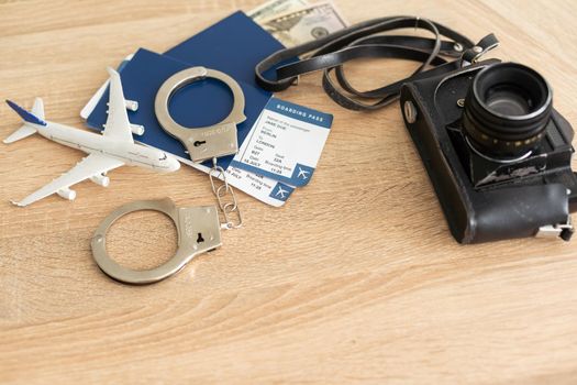 passport, tickets, toy plane, handcuffs.