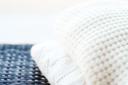 Knitwear, fabric textures and handmade items concept - Warm knitted clothes, soft and white