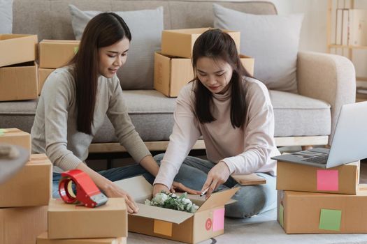 Two Asian SME business woman working at home office. online shopping concept.