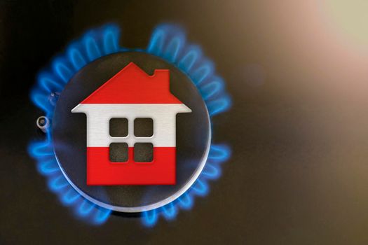 gas crisis. Rising utility costs in Austria. Energy crisis, export-import problems in Austria. The concept, gas burner and house model are colored in the colors of the flag