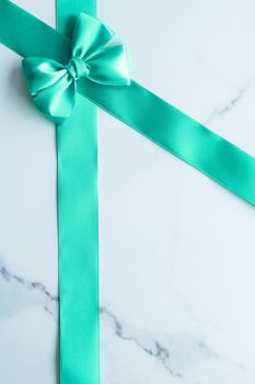 Holiday design, greeting card and vintage gift concept - Green silk ribbon on marble background, top view