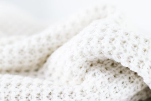 Knitwear, fabric textures and handmade items concept - Warm knitted clothes, soft and white