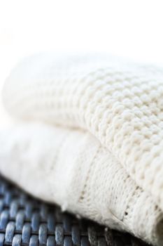 Knitwear, fabric textures and handmade items concept - Warm knitted clothes, soft and white