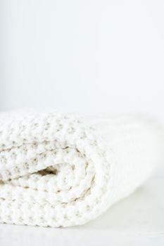 Knitwear, fabric textures and handmade items concept - Warm knitted clothes, soft and white