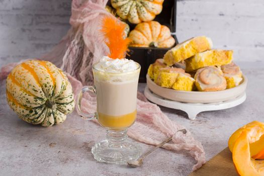pumpkin cinnabons and latte for dessert, holiday table with pastries, home sweet home, autumn menu. High quality photo