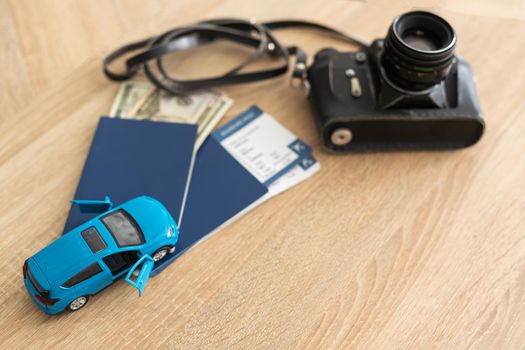 Passport, tickets and camera. toy car.
