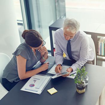 Take a look at this. two businesspeople sitting in a meeting