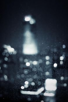 Big metropolitan city lights at night, blurry background - night life, abstract background and modern dark tones concept