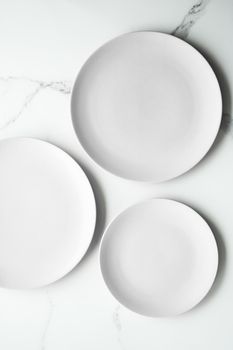 White empty plate on marble, flatlay - stylish tableware, romantic table decor and food menu concept. Serve the perfect dish