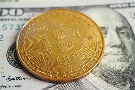 Golden bitcoin on US dollar banknotes money for business and commercial, Digital currency, Virtual cryptocurrency, blockchain technology.