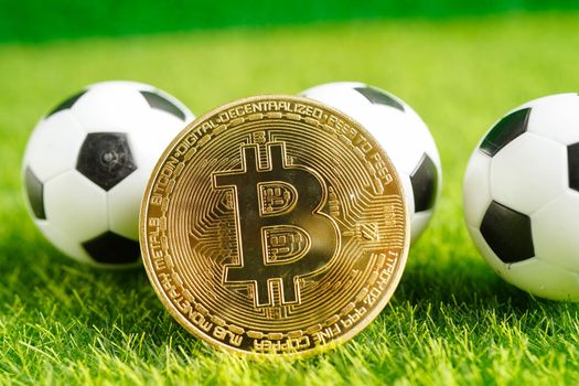 Gold bitcoin with soccer ball or football, cryptocurrency used in online sports betting.