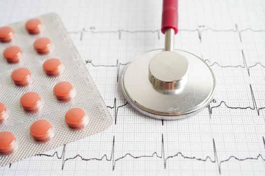 Stethoscope on electrocardiogram (ECG) with drug, heart wave, heart attack, cardiogram report.