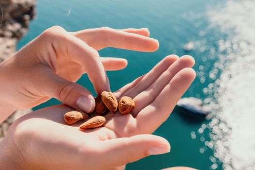 Unrecognizable caucasian woman eating young milky almond nuts. Healthy vegan food