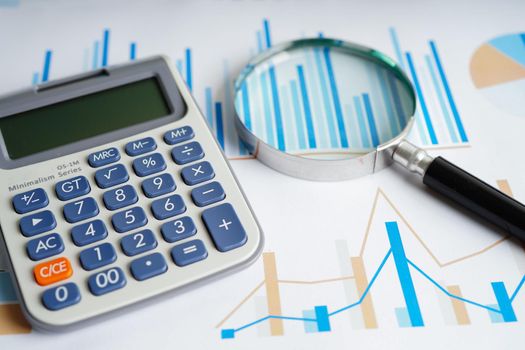 Calculator on chart and graph spreadsheet paper. Finance development, Banking Account, Statistics, Investment Analytic research data economy, Stock exchange trading, Business company concept.