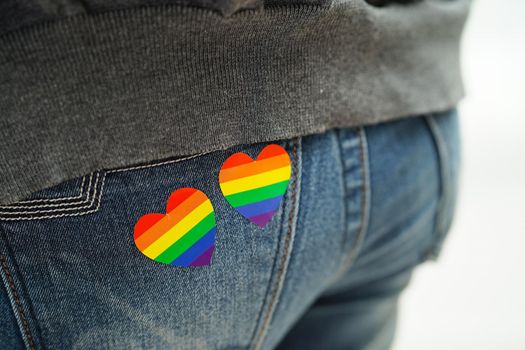 Asian woman with rainbow flag, LGBT symbol rights and gender equality, LGBT Pride Month in June.