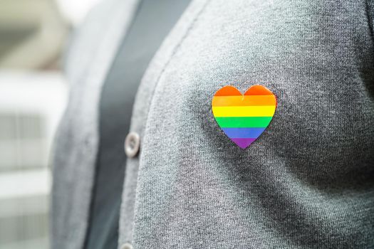 Asian woman with rainbow flag, LGBT symbol rights and gender equality, LGBT Pride Month in June.