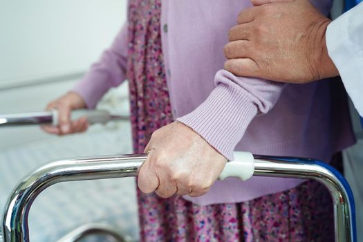Doctor help Asian elderly woman disability patient in nursing hospital, medical concept.