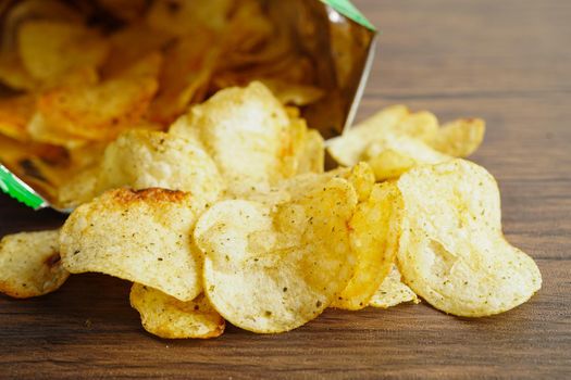 Potato chips in open bag, delicious BBQ seasoning spicy for crips, thin slice deep fried snack fast food in open bag.
