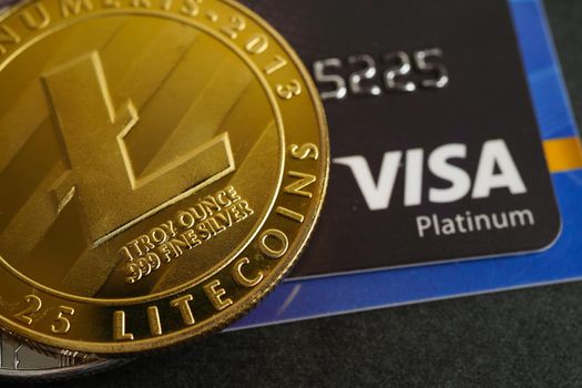 Bangkok, Thailand - December 15, 2021 Golden bitcoin with credit card on US dollar banknotes money for business and commercial, Digital currency, Virtual cryptocurrency.