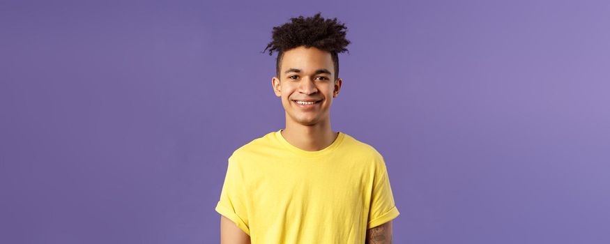 Close-up portrait of smiling, enthusiastic hispanic male student searching job, consider career opportunities, recruiting to company, smiling cheerful standing purple background.