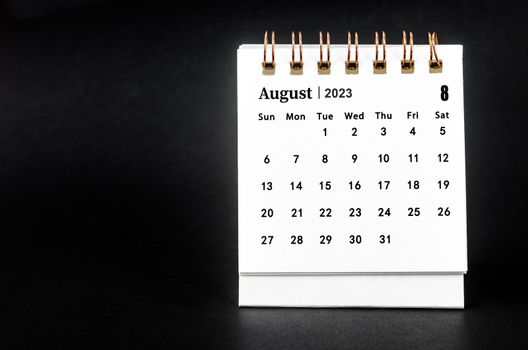 August 2023 Monthly desk calendar for 2023 year on black background.