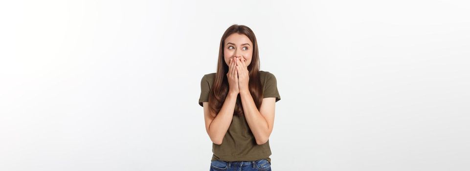 amazement - woman excited looking to the side. Surprised happy young woman looking sideways in excitement. Mixed race Asian and white Caucasian female model on grey background