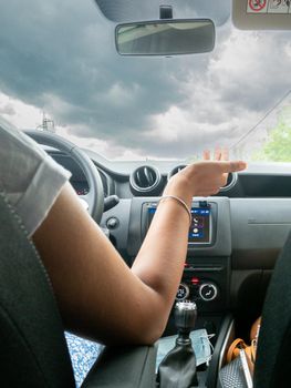 Beautiful business lady driving her car a cloudy day in summertime