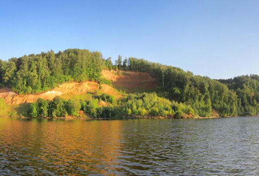 Russian River with cliff coast under clear blue sky. Scenic Colorful Nature Landscape of Russian Summer.