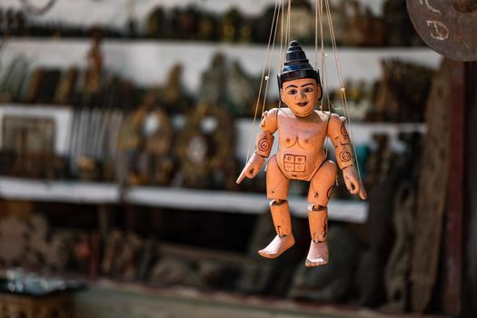 Close-up of a wooden puppet with threads and simple paint in Myanmar